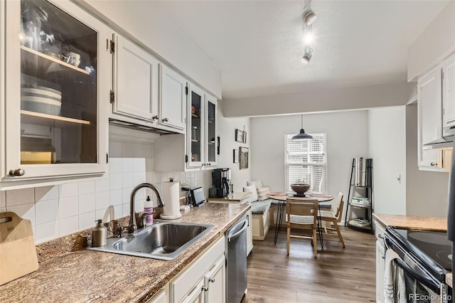 3141 S Tamarac Dr Unit 202E, Denver, CO 80231 - kitchen featuring a sink, dishwasher, black range with electric cooktop, backsplash, and glass insert cabinets