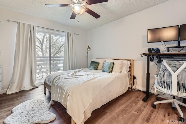 3141 S Tamarac Dr Unit 202E, Denver, CO 80231 - bedroom with a ceiling fan, a textured ceiling, access to exterior, wood finished floors, and lofted ceiling