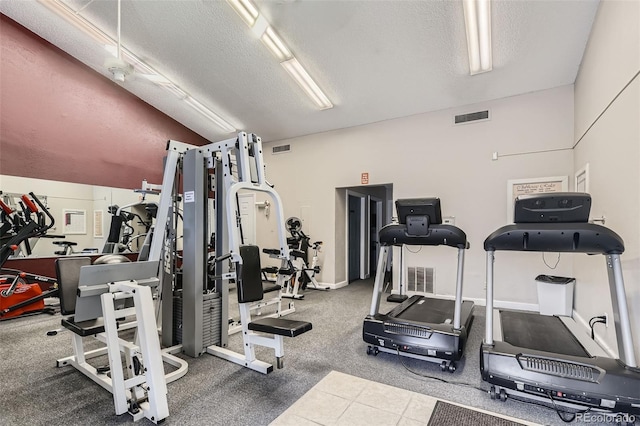 3141 S Tamarac Dr Unit 202E, Denver, CO 80231 - workout area featuring a textured ceiling, visible vents, and lofted ceiling