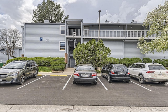 3141 S Tamarac Dr Unit 202E, Denver, CO 80231 - view of building exterior featuring uncovered parking