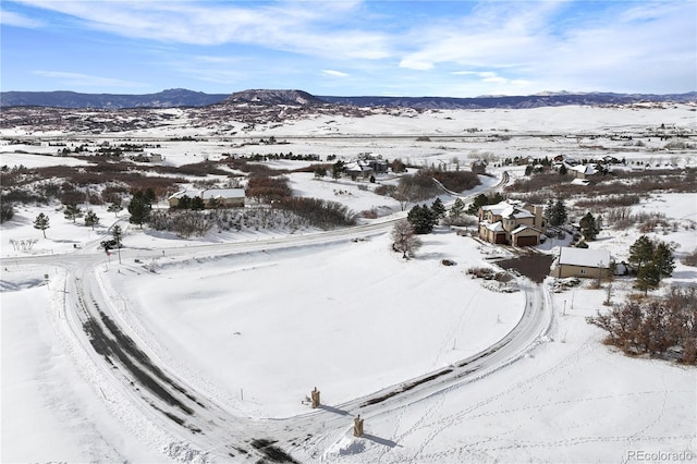 snowy aerial view featuring a mountain view