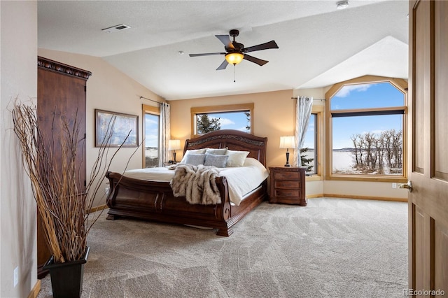 carpeted bedroom featuring vaulted ceiling, a ceiling fan, visible vents, and baseboards