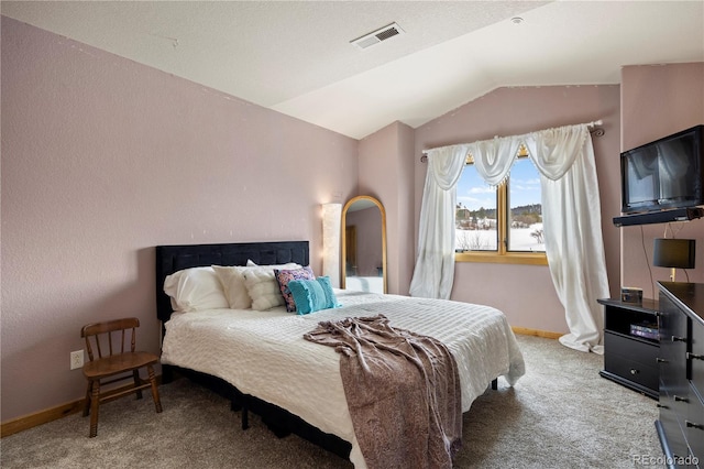 carpeted bedroom with lofted ceiling, visible vents, and baseboards