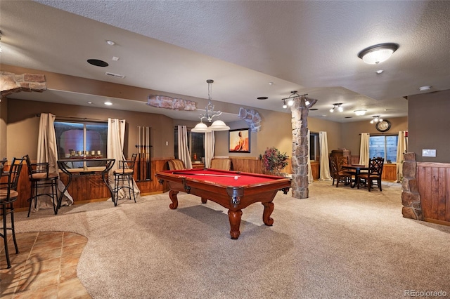 rec room with light colored carpet, pool table, and a textured ceiling