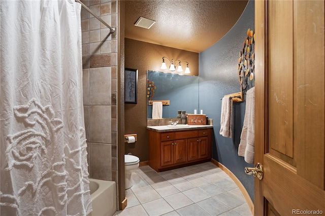 full bathroom featuring a textured ceiling, a textured wall, tile patterned flooring, toilet, and vanity