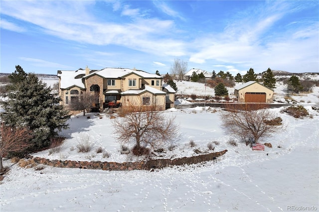 yard layered in snow featuring a garage