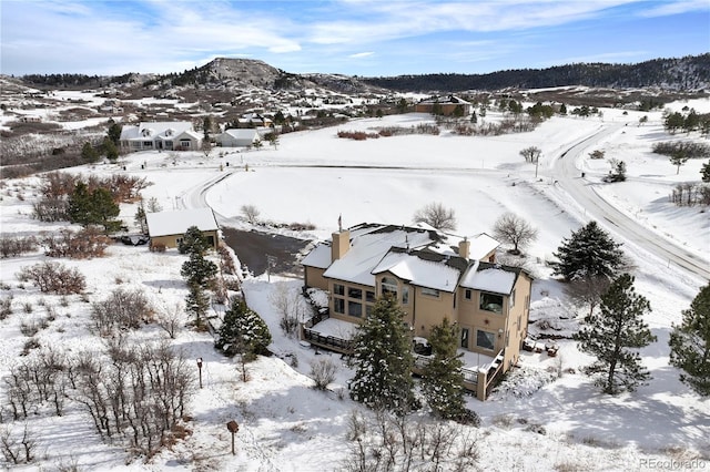 snowy aerial view with a mountain view