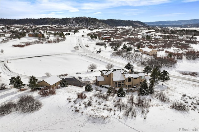 snowy aerial view with a mountain view