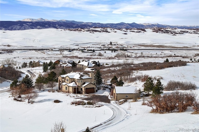 snowy aerial view with a mountain view