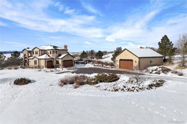 view of front of house featuring a detached garage and stucco siding