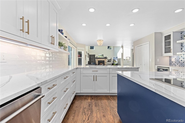 kitchen with white cabinetry, dishwasher, light stone countertops, and dark wood-type flooring