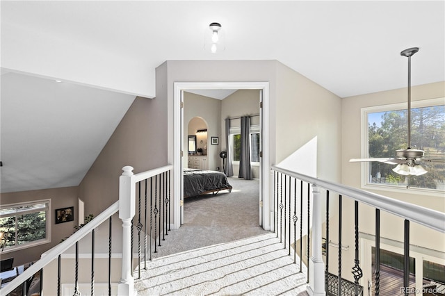 corridor featuring light colored carpet