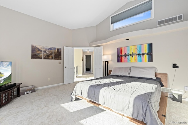 bedroom with high vaulted ceiling and carpet flooring