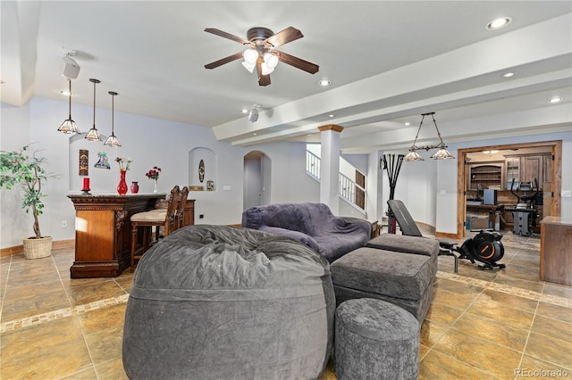 living room with ceiling fan and indoor bar