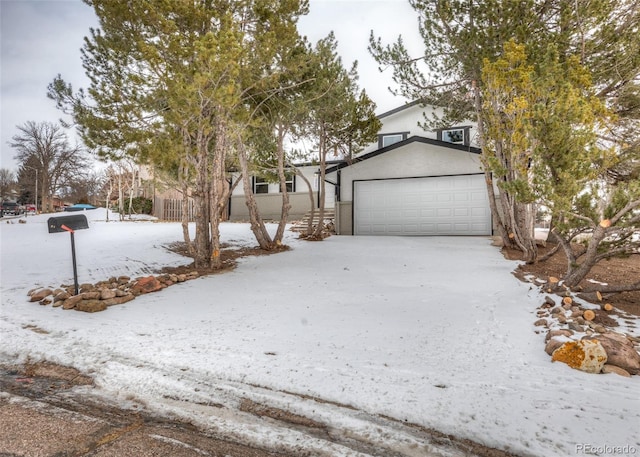 view of front of house featuring a garage and stucco siding