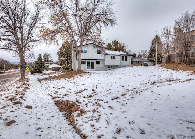 view of snow covered back of property