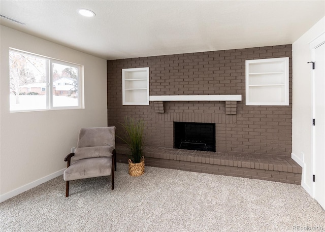 living area featuring a fireplace, built in features, and carpet flooring