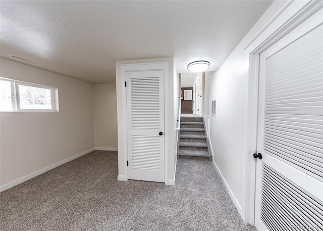 hallway featuring light carpet