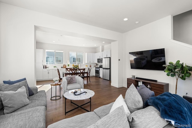 living room featuring dark wood-style floors, baseboards, and recessed lighting