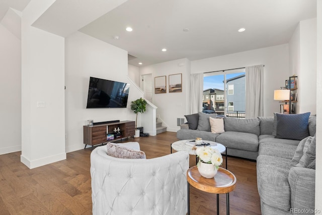 living area featuring recessed lighting, visible vents, stairway, wood finished floors, and baseboards