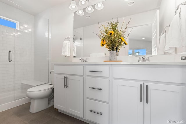 bathroom with a stall shower, tile patterned flooring, toilet, and double vanity