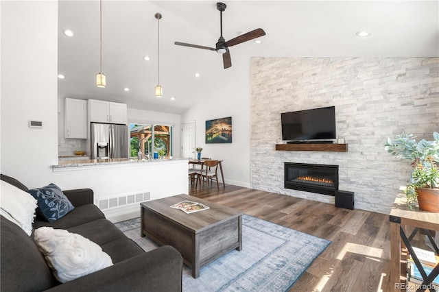6604 S Dahlia Cir, Centennial, CO 80121 - living area with a ceiling fan, wood finished floors, a stone fireplace, recessed lighting, and high vaulted ceiling