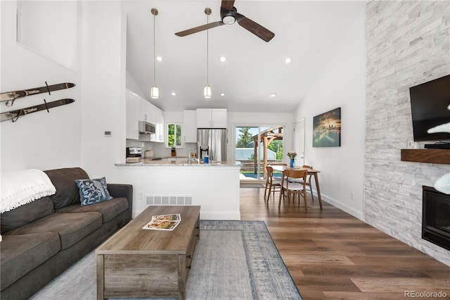 6604 S Dahlia Cir, Centennial, CO 80121 - living area with high vaulted ceiling, a ceiling fan, wood finished floors, and recessed lighting