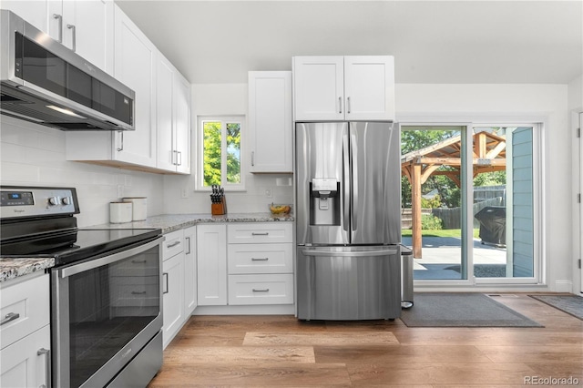 6604 S Dahlia Cir, Centennial, CO 80121 - kitchen featuring appliances with stainless steel finishes, plenty of natural light, and white cabinets