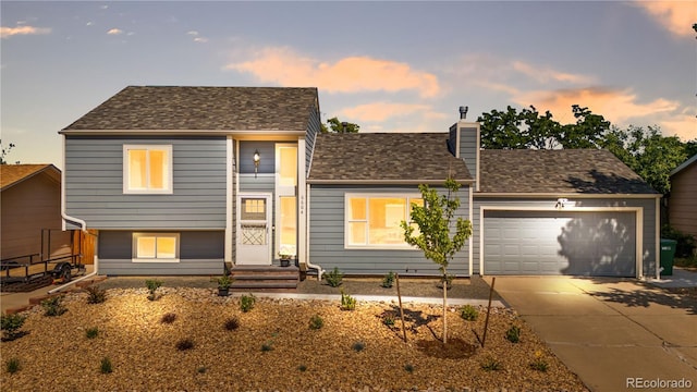 6604 S Dahlia Cir, Centennial, CO 80121 - view of front of property featuring a garage, driveway, and a chimney