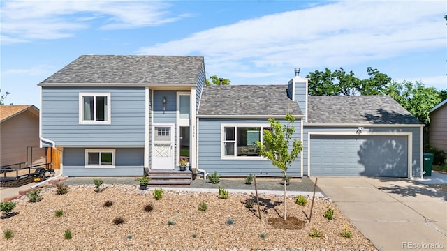 6604 S Dahlia Cir, Centennial, CO 80121 - view of front of home featuring an attached garage, driveway, and a chimney