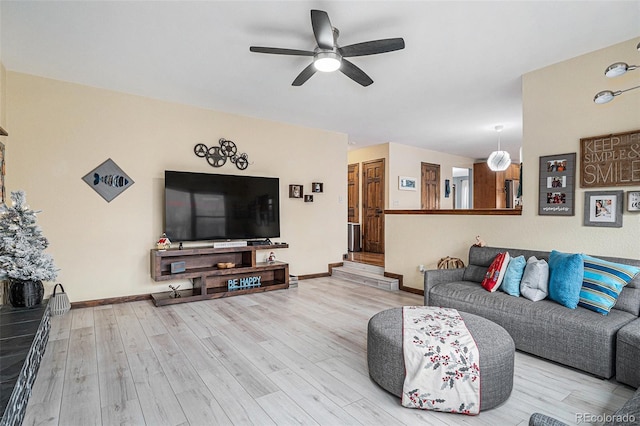 living room with ceiling fan and light hardwood / wood-style floors