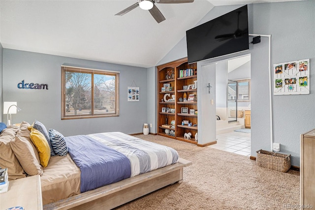 bedroom with light carpet, connected bathroom, multiple windows, and lofted ceiling