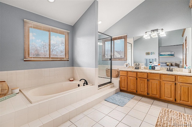 bathroom featuring tile patterned floors, lofted ceiling, separate shower and tub, and vanity