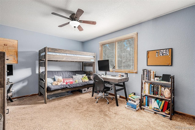 carpeted bedroom featuring ceiling fan and a textured ceiling