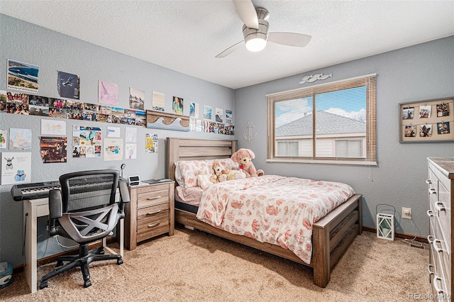 bedroom with light carpet, ceiling fan, and a textured ceiling