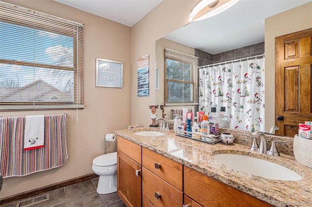 bathroom featuring a shower with curtain, vanity, tile patterned floors, and toilet