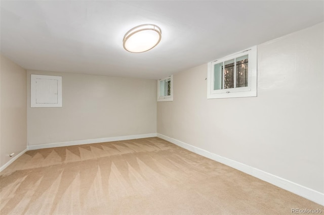 basement featuring light carpet