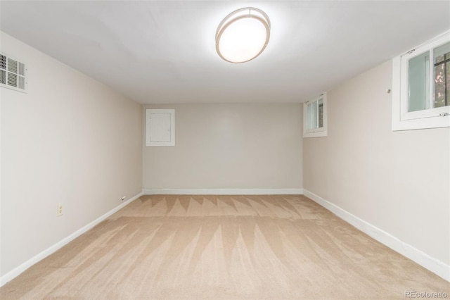 basement featuring light carpet