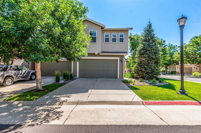 6190 S Oswego St, Englewood, CO 80111 - view of front facade with concrete driveway, an attached garage, stucco siding, and a front lawn
