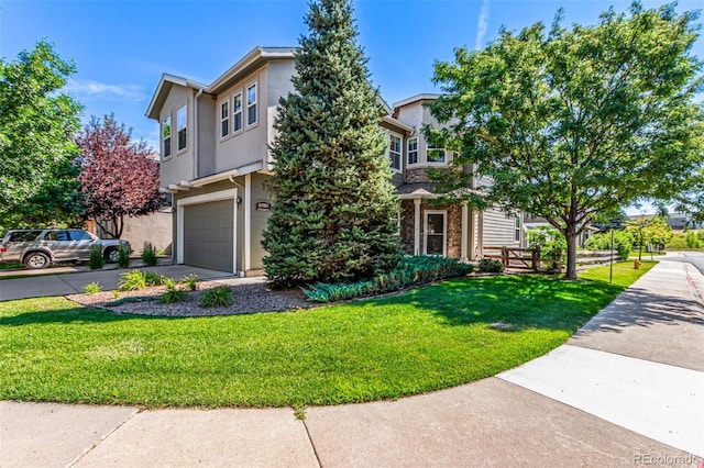 6190 S Oswego St, Englewood, CO 80111 - view of front of house featuring an attached garage, driveway, a front lawn, and stucco siding