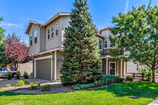 6190 S Oswego St, Englewood, CO 80111 - view of front of house with a garage, a front lawn, driveway, stucco siding, and stone siding