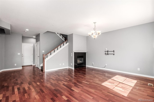 6190 S Oswego St, Englewood, CO 80111 - unfurnished living room featuring wood finished floors, a chandelier, stairway, and recessed lighting