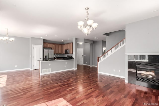 6190 S Oswego St, Englewood, CO 80111 - unfurnished living room with a chandelier, a fireplace, wood finished floors, and recessed lighting