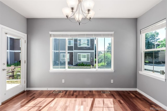 6190 S Oswego St, Englewood, CO 80111 - unfurnished room featuring a chandelier, plenty of natural light, and wood finished floors