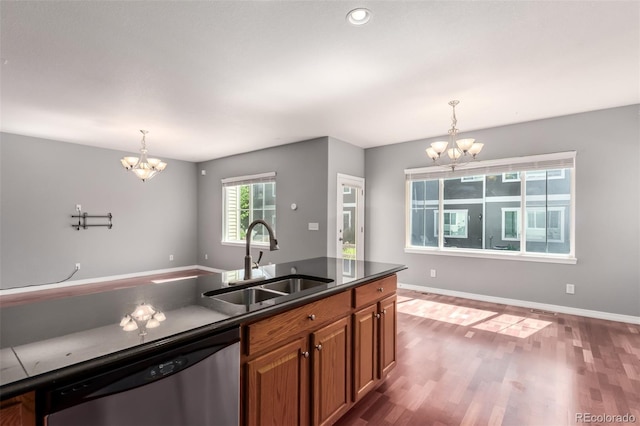 6190 S Oswego St, Englewood, CO 80111 - kitchen with a chandelier, stainless steel dishwasher, dark countertops, brown cabinets, and recessed lighting