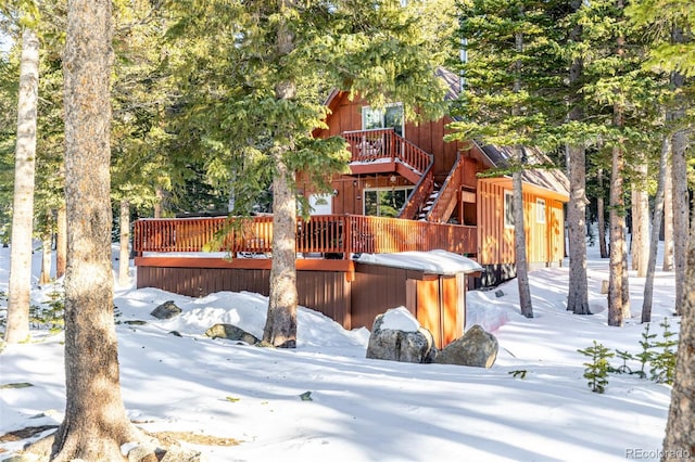 snow covered deck with a hot tub