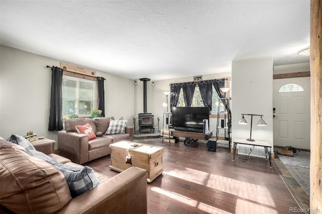 living room featuring a wood stove and dark hardwood / wood-style floors