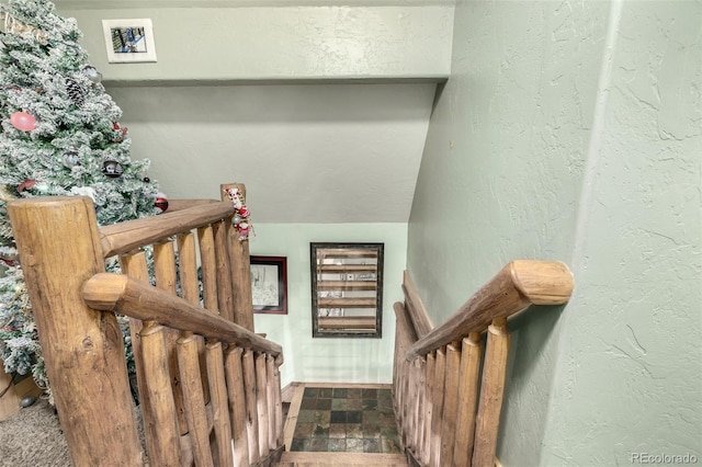 stairway featuring vaulted ceiling