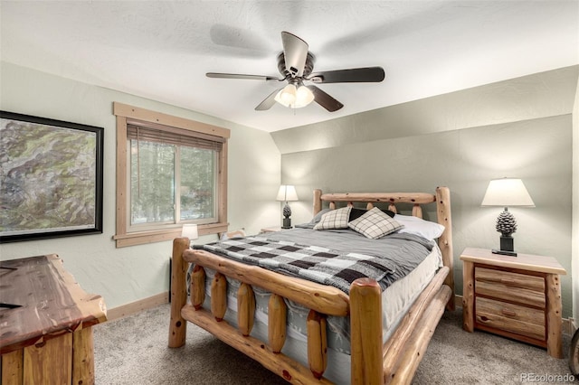 carpeted bedroom featuring ceiling fan, a textured ceiling, and lofted ceiling