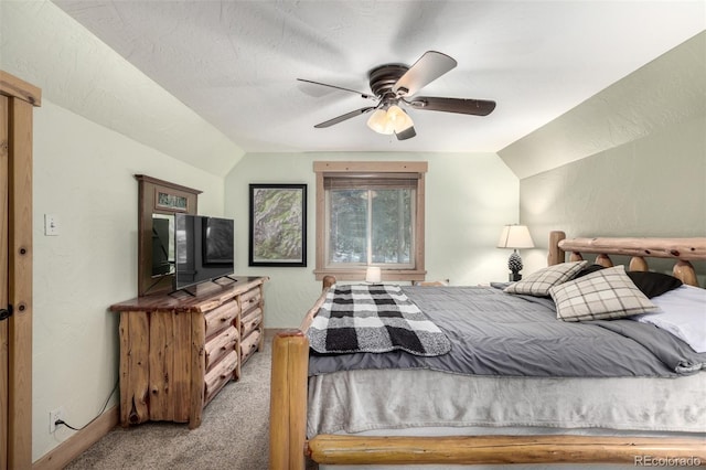 bedroom featuring lofted ceiling, ceiling fan, carpet floors, and a textured ceiling